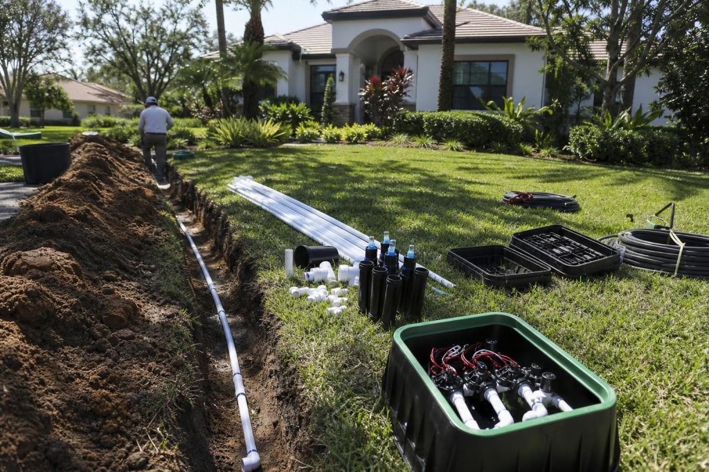 Irrigation installation underway in a Sun City Center Florida yard showing trenches and sprinkler components
